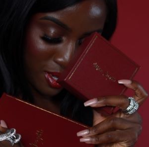 Woman holds a red box with a ring, highlighting the elegance of Maison Georgette's affordable luxury jewelry