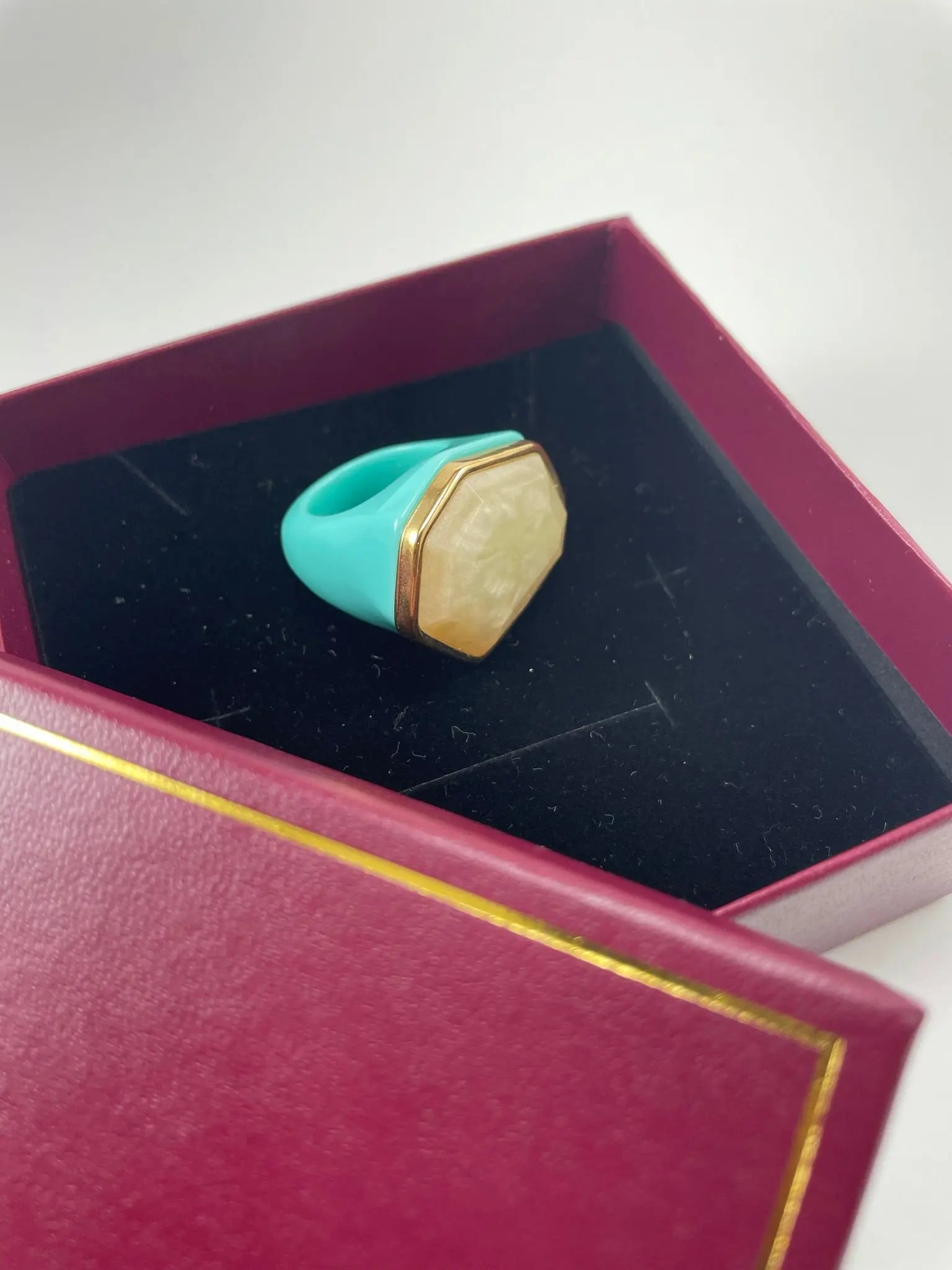 A stunning turq stone ring nestled in a box, representing luxury women's ring jewelry