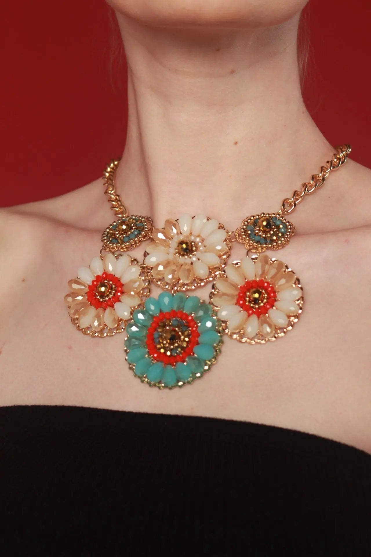 A woman displays a vibrant flower necklace, the Daisy Bib Necklace suitable jewelry for special occasions
