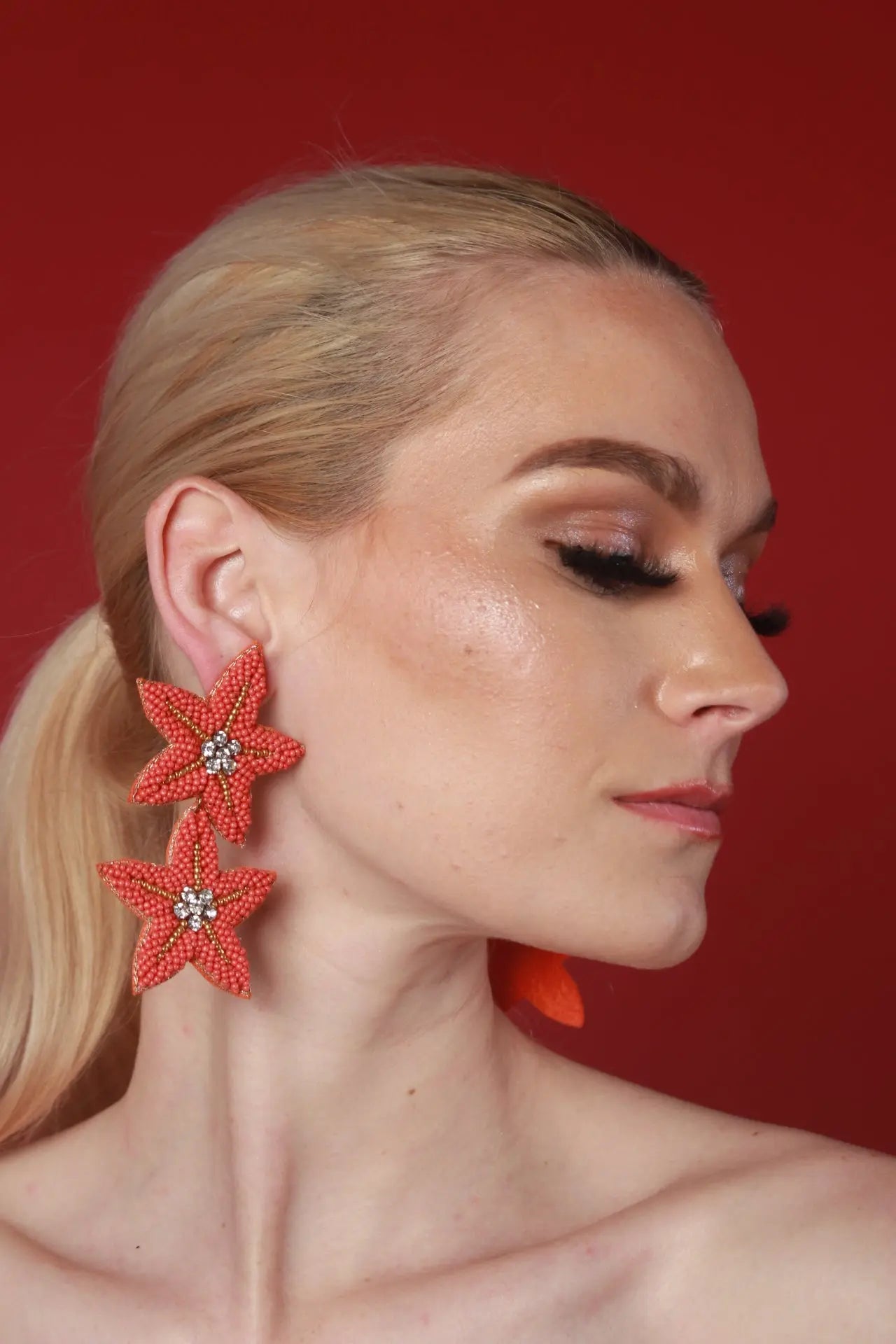 A woman wears a Sea Star earring, representing the essence of timeless jewelry